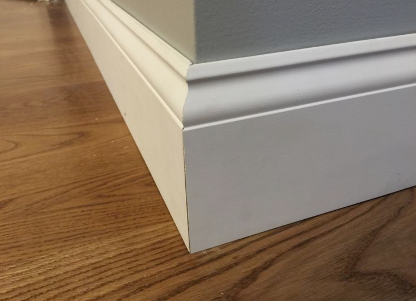 9/16-in x 5-1/4-in x 8-ft Colonial Primed Pine Baseboard Moulding Trim (Pack of 8)